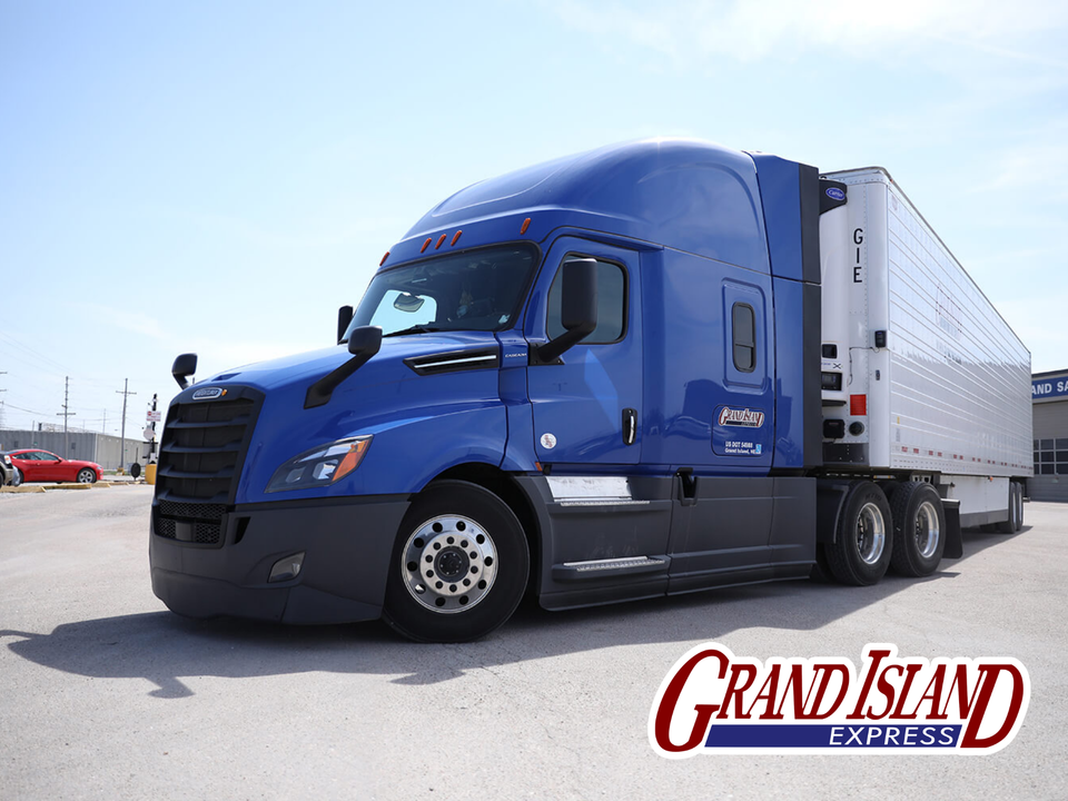 Grand Island express truck in yard with logo in corner